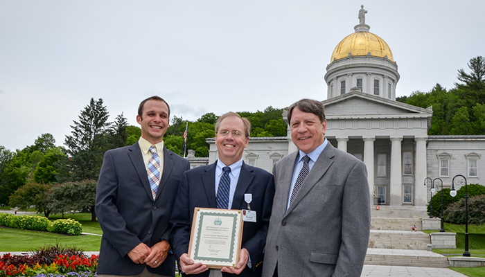 Tim Perrin, Richard Morley and Leo Martino hold Governor's Award in front of state house
