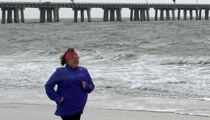 Candace Brown running on beach in Virginia at the end of February