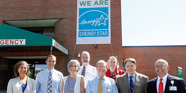 CVMC staff stands in front of Energy Star banner