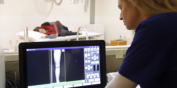 Technician studies leg x-ray