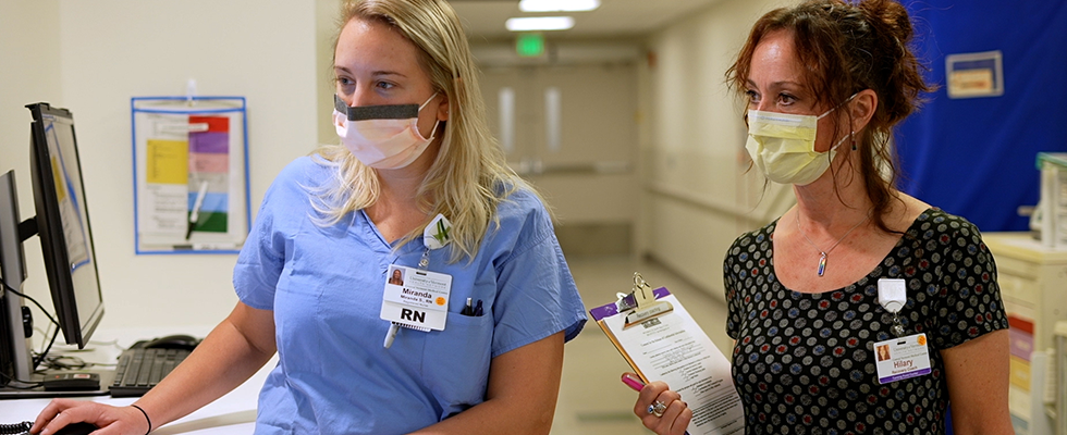 Recovery Coach Program Manager Hilary Denton consults with Miranda Snyder, RN in the CVMC Emergency Department.