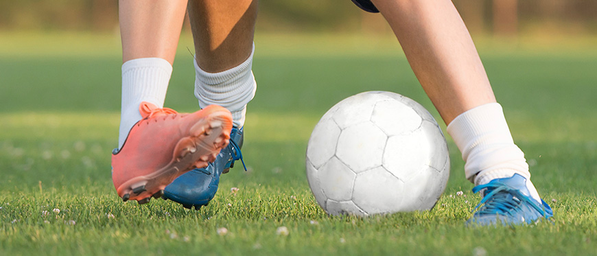 Close up of feet playing soccer