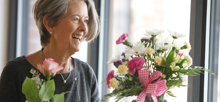 Visitor bringing flowers to patient
