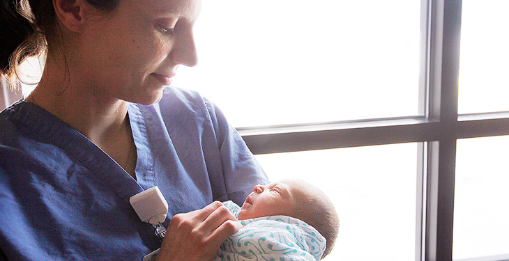 Nurse holding baby