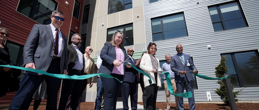 UVM Health Network leaders cutting ribbon at new Burlington apartment complex