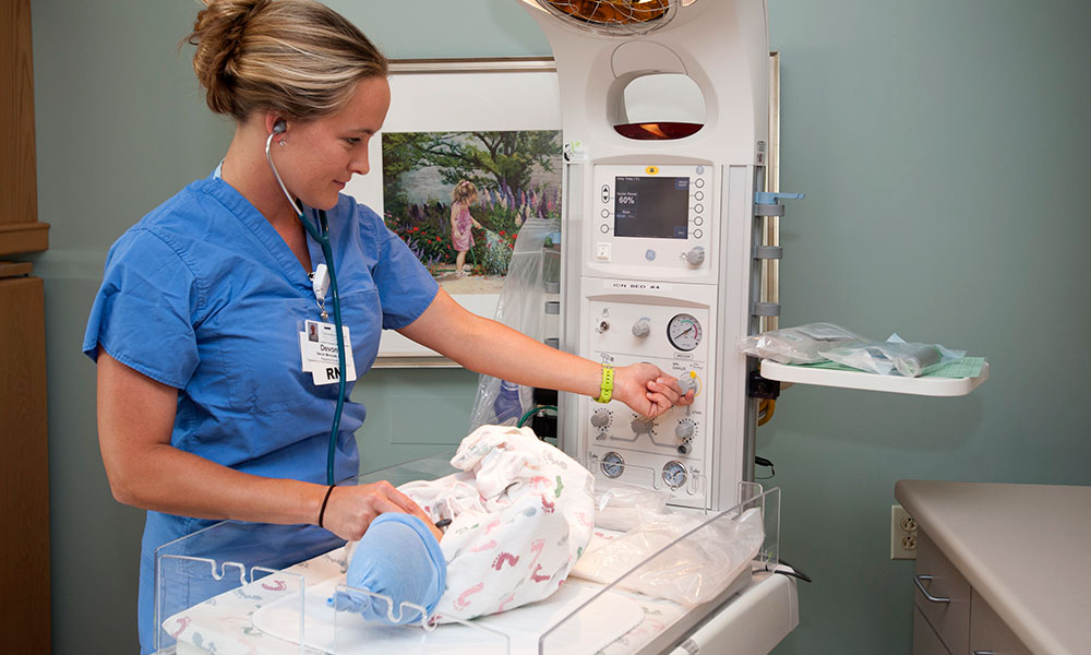 Nursing checking newborn's heart