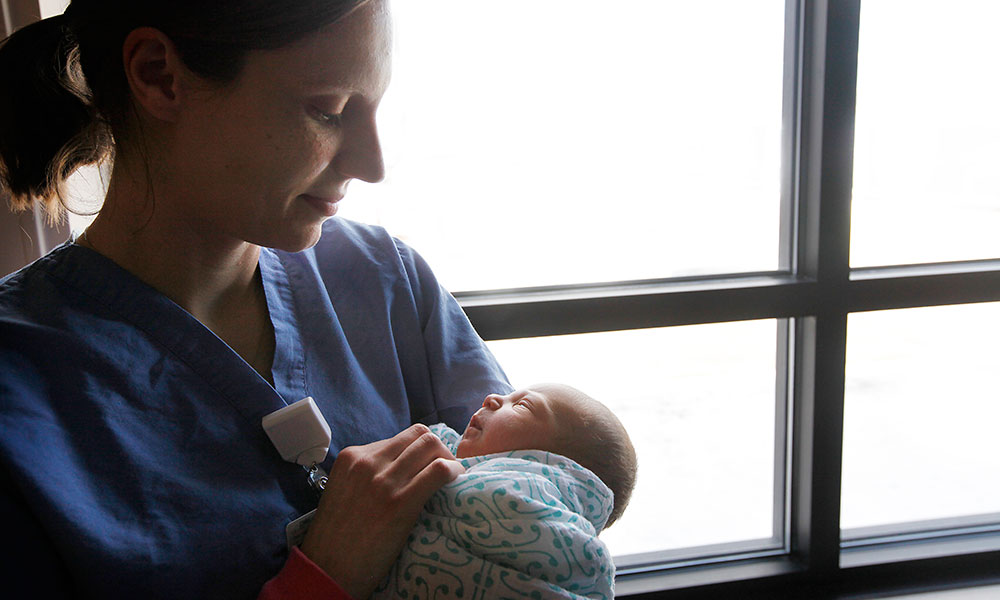 Nurse holding newborn