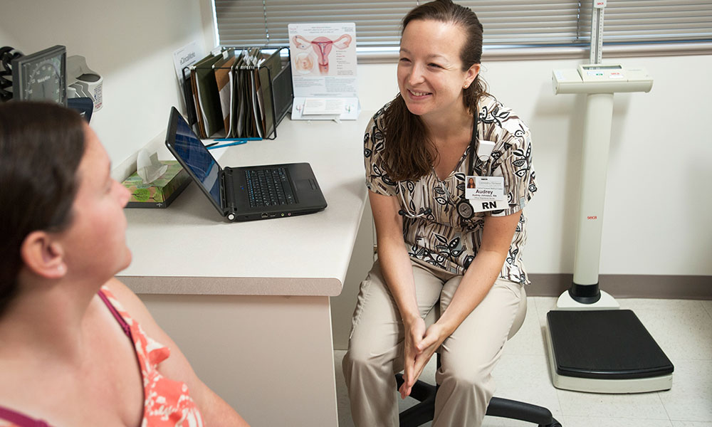 Nurse consulting with patient during prenatal visit