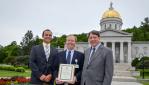 Tim Perrin, Richard Morley and Leo Martino hold Governor's Award for Environment Excellence in front of state house