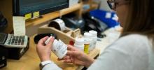 UVM Health Network staff member reviews pill bottle label.