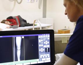Technician studies leg x-ray